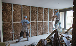 Two construction workers working on a building