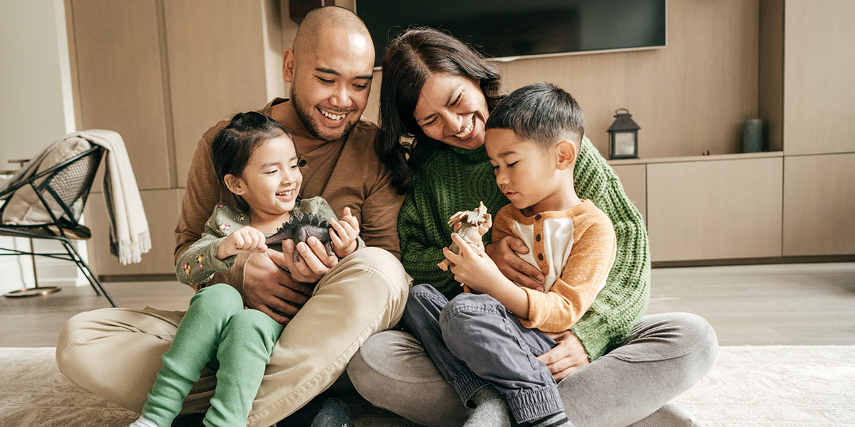 family sitting on floor smiling