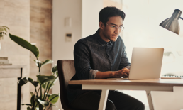 Man working at desk on laptop