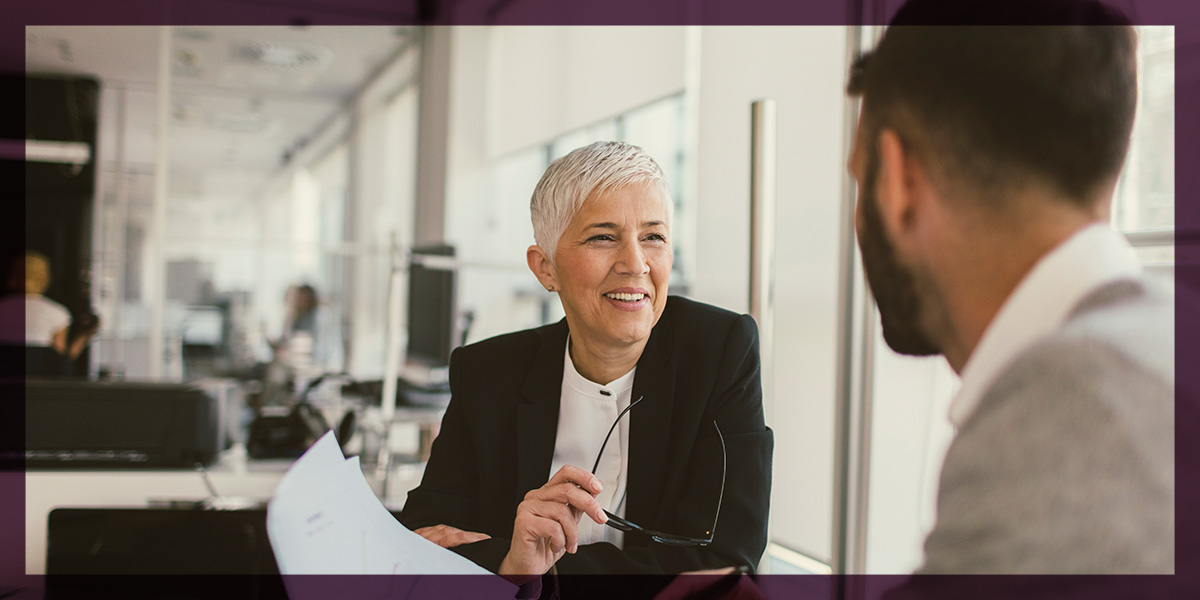 woman and man talking in a business environment
