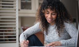 Young woman taking down notes.