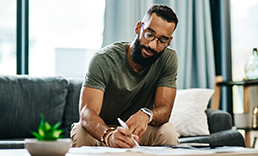 Man signing a document.