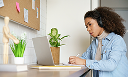 Young woman looking at laptop computer.