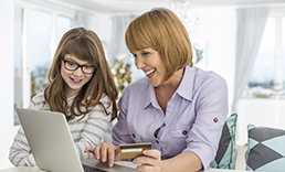 Mother and daughter making an online purchase.