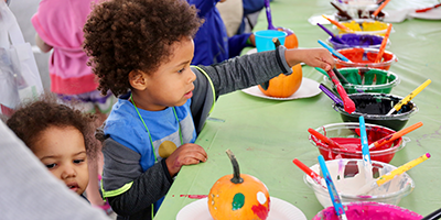 children painting pumpkins