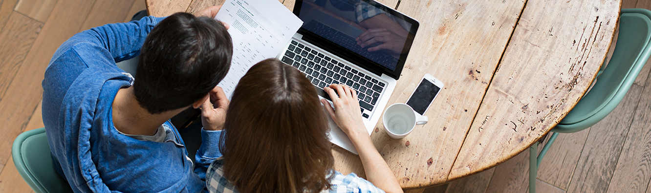 overhead view of couple looking at a computer