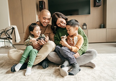 family sitting on the floor in a home