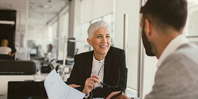 woman talking to a man in a business setting