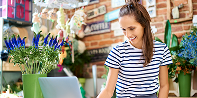 woman smiling looking at computer