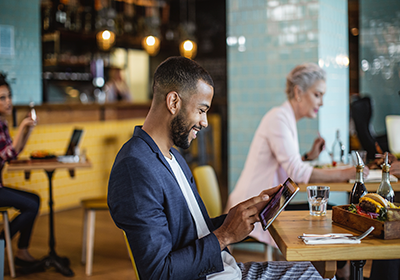 man smiling looking at mobile device