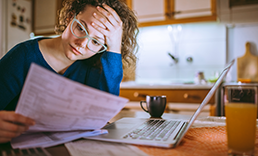 Woman looking at paper stressfully