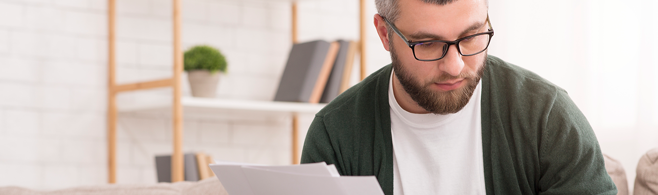 man looking at paperwork