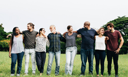 A diverse group of individuals hugging each other.