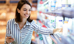 Woman picking out groceries.