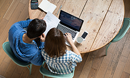 overhead view of man and woman looking at a computer