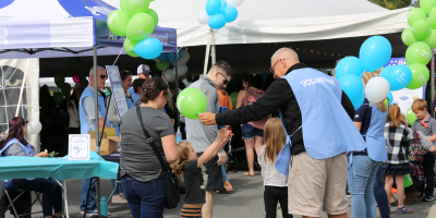 Thomas Signor - EVP & Chief Administrative Officer handing out balloons at Pioneer Grand Carnival
