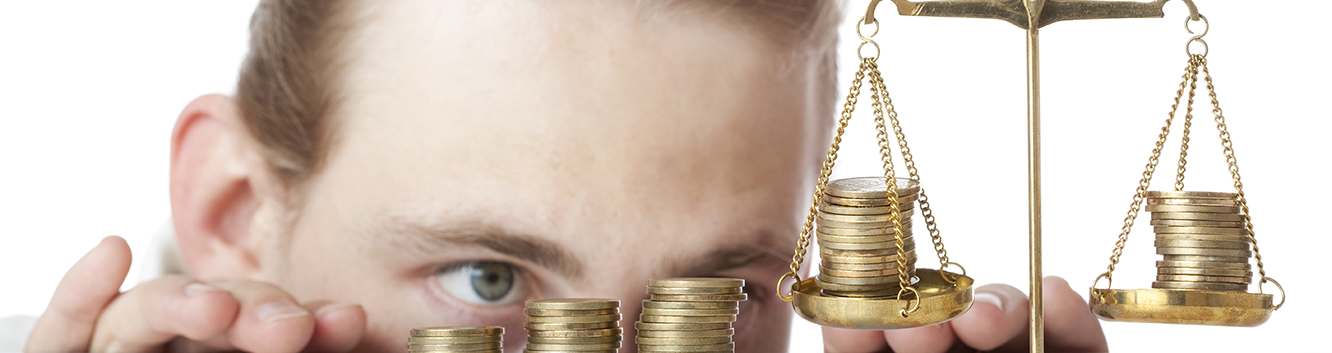 person looking at coins on a scale