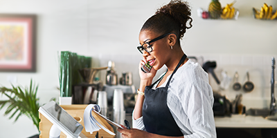 woman on the phone looking at tablet