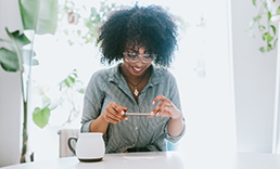 Woman at table taking picture of a check