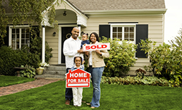 family in front of new home