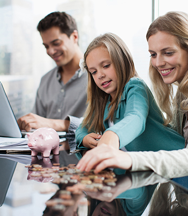 family counting coins and working on a computer