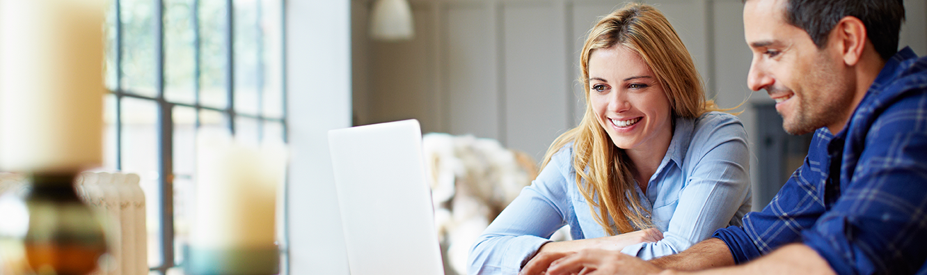 man and woman looking at laptop