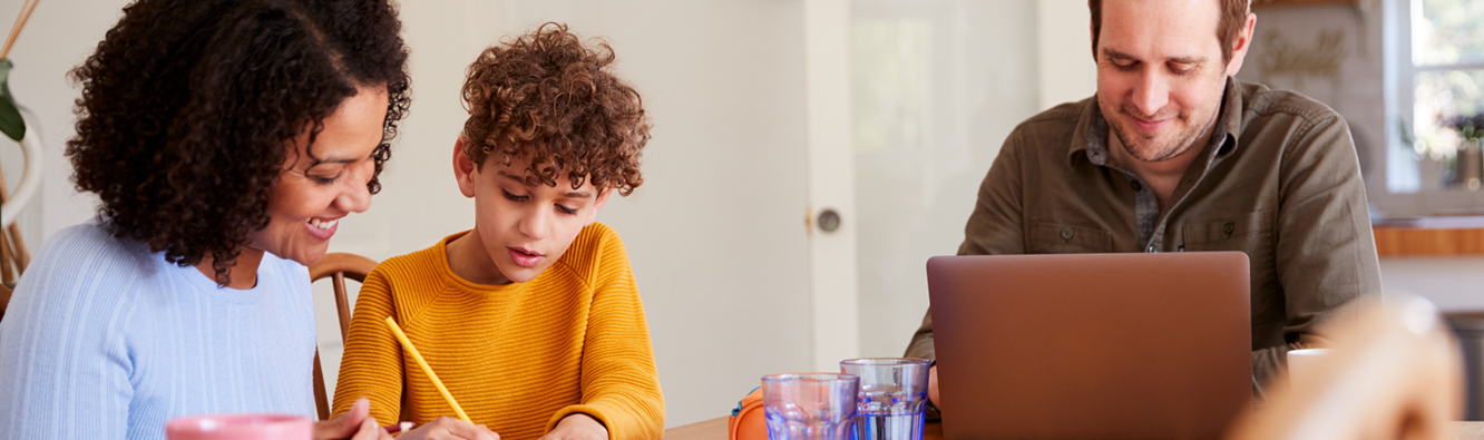 family doing homework at table