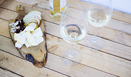 Cheese board and a bottle of wine.