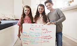 Children showing off their completed chores list.