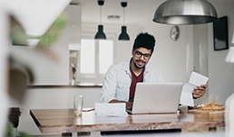 A man paying bills on his laptop.