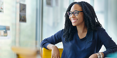 woman looking out glassdoors smiling