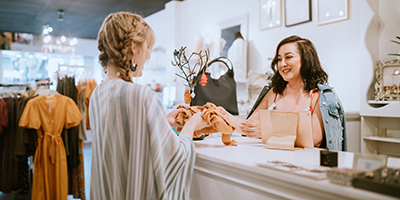 woman paying at store counter