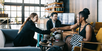 Colleagues meeting each other and shaking hands during meeting