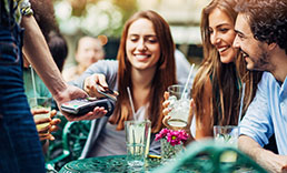 College students paying their bill at a restaurant.