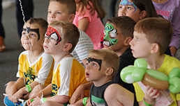 children with face paint and balloons