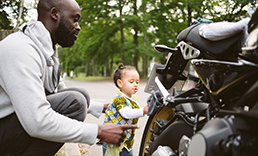 Father and daughter cleaning their motorcycle.