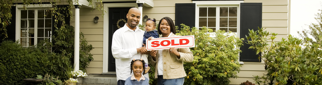 family outside of new home