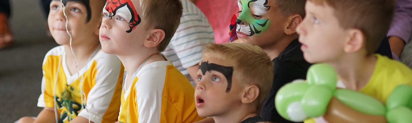 children with face paint and balloons