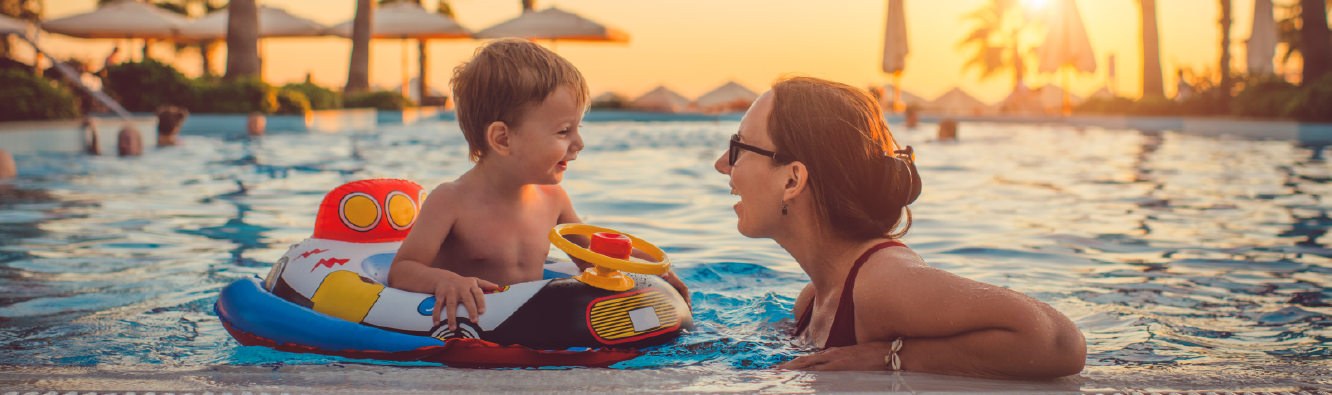 Mother and son in a resort pool on vacation.