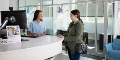 Teller at a Pioneer branch helping a customer