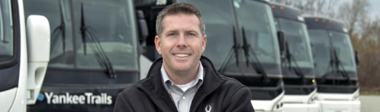 man standing in front of buses