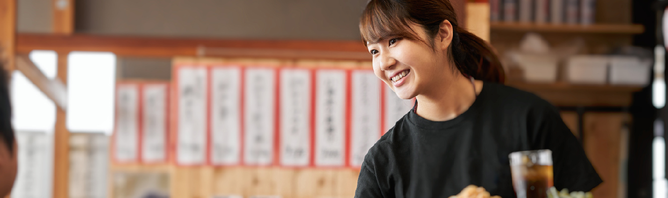 Female waitress serving drink in a restaurant