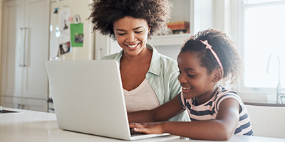 woman and child working on a laptop