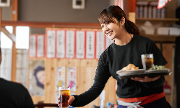 Female waitress serving drink in a restaurant