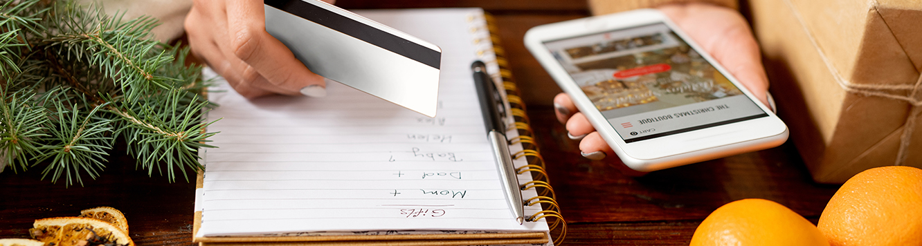 person holding a card and a mobile device