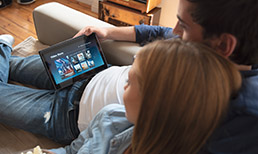 Couple watching a streaming service on a tablet.